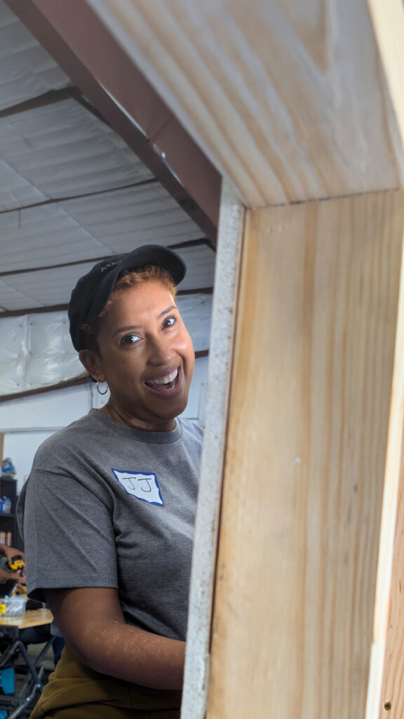 A woman smiling at the camera during a tool training session.